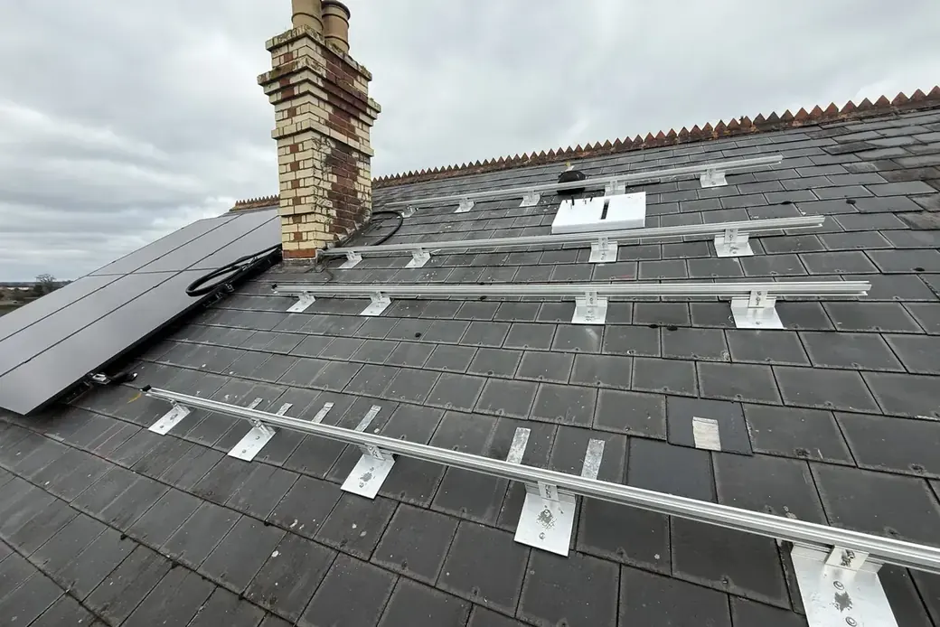 Mounting rails and fixing points positioned across a slate roof