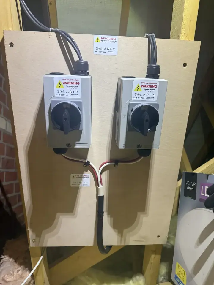 Two labelled SolarFX PV DC isolators mounted on a board
