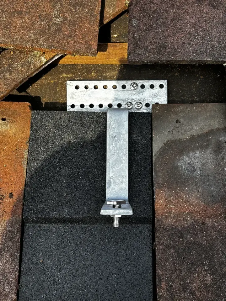 Renusol roof hook fixed to the roof structure beneath a lifted tile