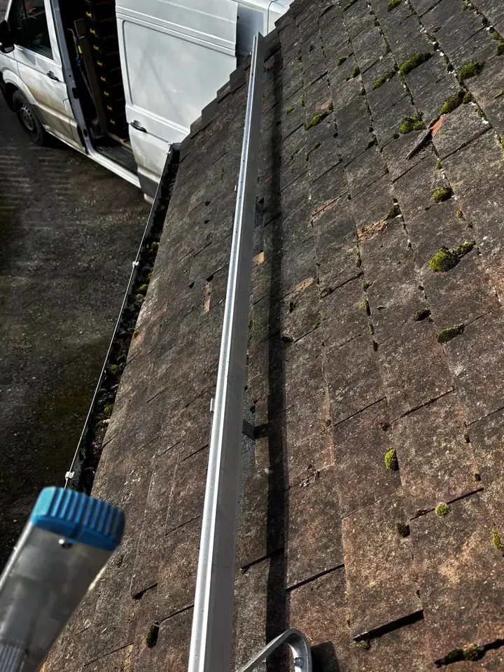 Mounting rail running across the tiled roof before panels were fitted