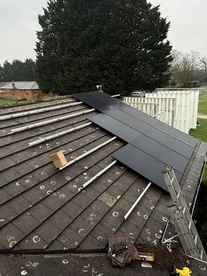 Mounting rails and fixings across the roof with the first panels in place